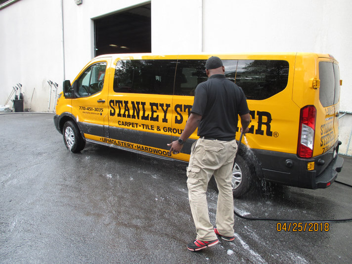 Atlanta Ga Cleaning Services Stanley Steemer Atlanta Georgia Crew Member Cleaning The Exterior Of A Carpet Service Van