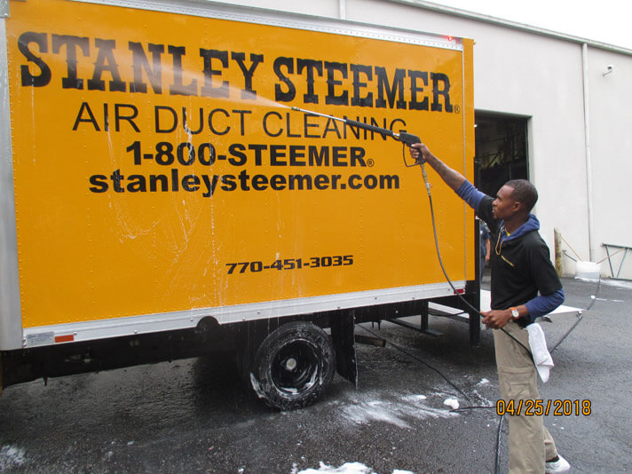 Atlanta Ga Cleaning Services Stanley Steemer Atlanta Georgia Crew Member Cleaning The Exterior Of A Air Duct Service Van